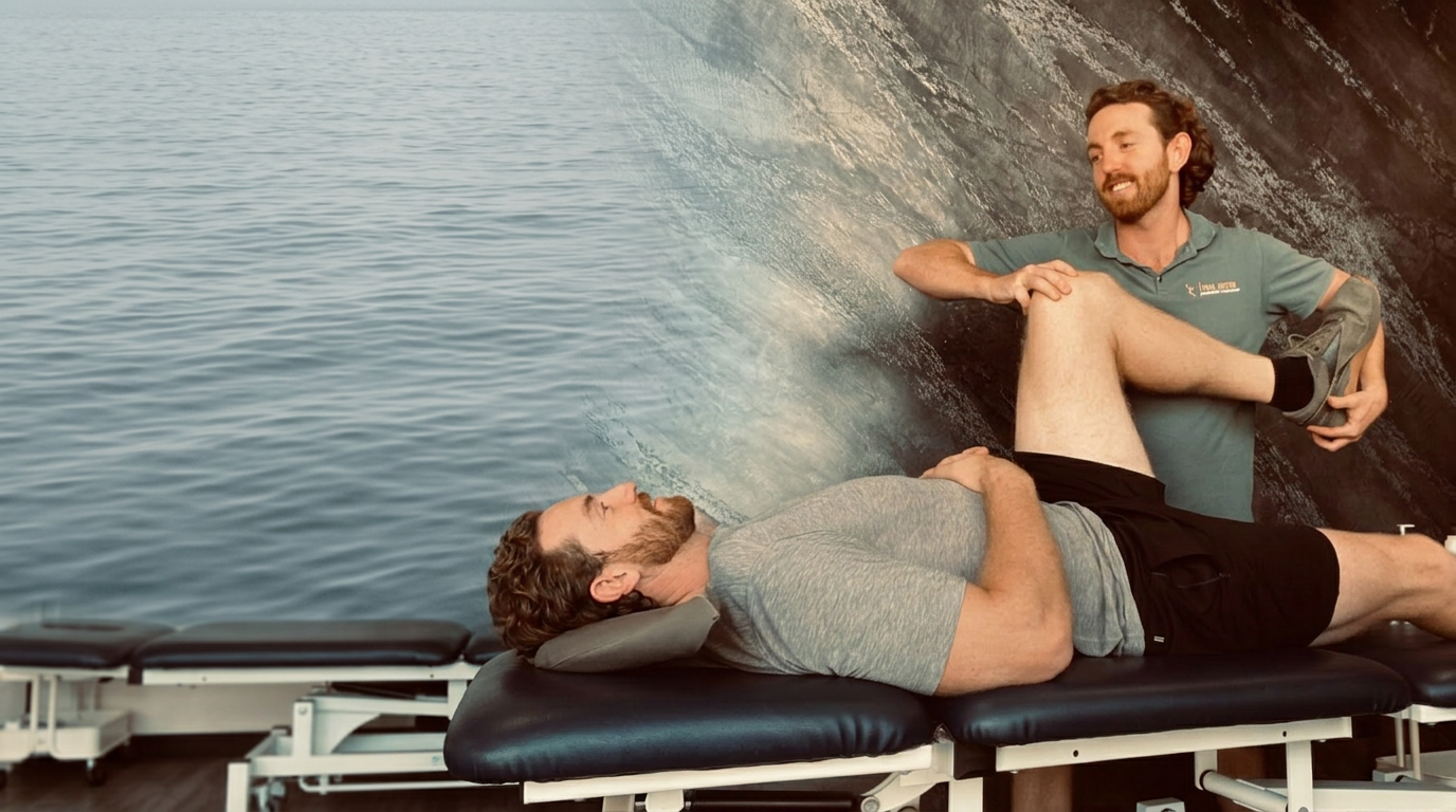 Josh from Tidal Motion treating a patient with a calm ocean backdrop